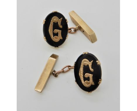 A pair of 9ct gold and onyx 'G' cufflinks, weight 7.1gms Condition Report: Claws a bit snaggy could do with attention, one of