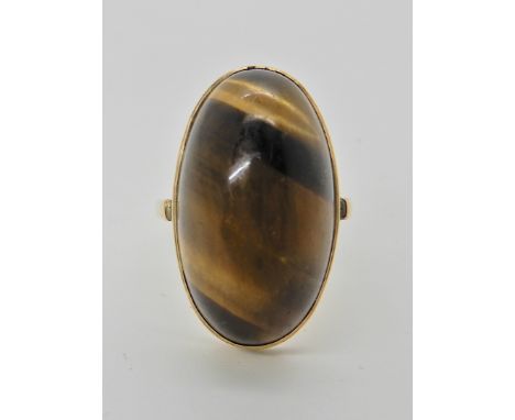 A 9ct gold mounted tigers eye ring stone approx 24mm x 14mm, finger size Q1/2 Condition Report: Available upon request