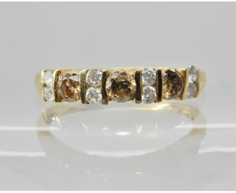 A 9ct gold QVC champagne and white diamond line ring, set with estimated approx 0.40cts of diamonds. Size O, weight 1.7gms Co