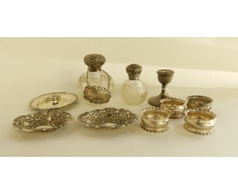 A lot comprising two silver topped scent bottles, a silver candlestick, a silver dish, a pair of silver bon bon dishes, a dec