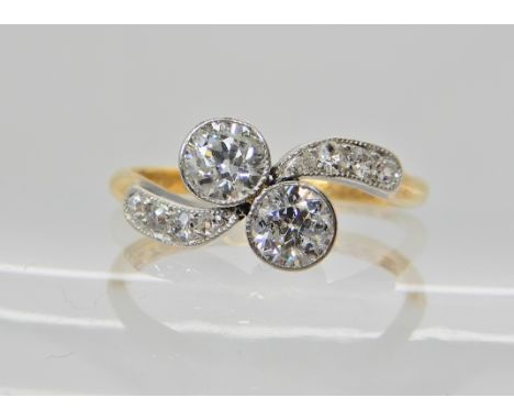 A 18ct gold classic twin stone on a twist combined diamond weight estimated approx 0.60cts, finger size O, weight 2.5gms Cond