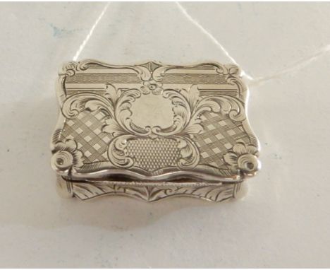 A silver vinaigrette by Edward Smith, Birmingham 1857, of rectangular form with engine turned decoration and hinged inner gri