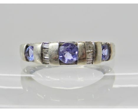 A 9ct white gold Tanzanite and diamond accent ring, tanzanite approx 4.1mm, finger size O, weight 2.9gms Condition Report: Ta