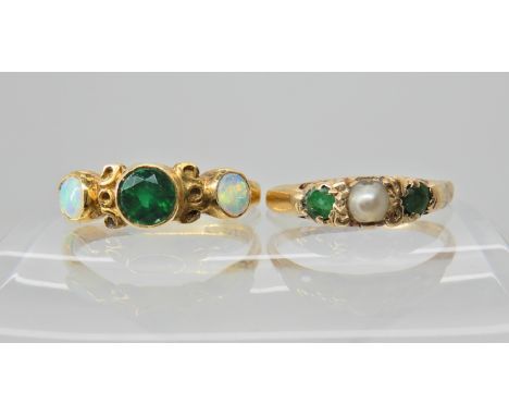 An 18ct gold emerald and opal set ring, size N1/2, and a yellow metal emerald and pearl set ring, size K, weight together 4.4