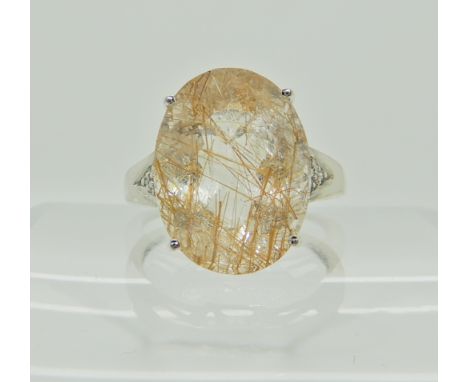 A 9ct white gold rutilated quartz and diamond accent dress ring, size Q1/2, weight 4.7gms Condition Report: Available upon re