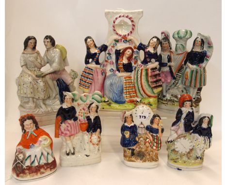 Seven Staffordshire flatbacks including little red riding hood, a watch holder modelled as Scottish dancers, two figures with