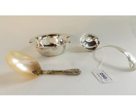 A lot comprising a silver dish, Sheffield 1902, a Continental silver sauce ladle, 16cm long and a white-metal and mother of p