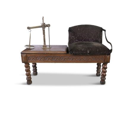 An EDWARDIAN OAK AND BRASS MOUNTED JOCKEY SCALES, fitted with upholstered seat and brass counter scales, with brass side hand