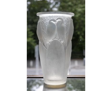 A LALIQUE 'CEYLAN' GLASS VASE, of circular tapering form with lipped rim, iridescent tones moulded in relief with pairs of bi