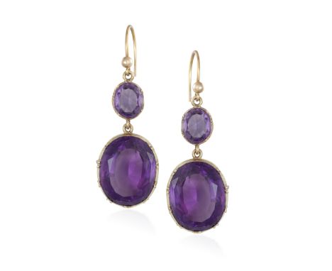 AN AMETHYST RING WITH A PAIR OF EARRINGS EN SUITE, the ring set with an oval-shaped amethyst to a plain gold hoop, ring size 