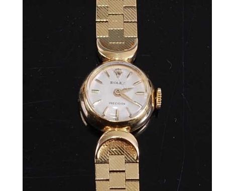 A lady's Rolex Precision 18ct yellow gold manual wind wristwatch, with round cream baton dial and integral textured brick lin