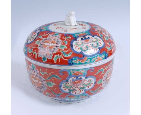 A Japanese Meiji period Kenjo Imari bowl and cover, the lid with shisa finial, enamel decorated with flowers, Fuki Choshun ma