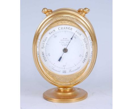 An early 20th century lacquered brass travelling desk aneroid barometer / thermometer, having white enamel barometer dial sig