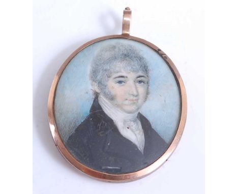 An early 19th century double-sided portrait mourning locket, one side being a portrait miniature of a grey haired and sidebur