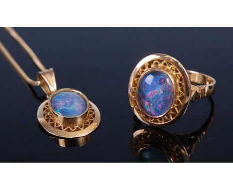 A yellow metal opal doublet suite, comprising pendant with an oval 9.65 x 7.4 x 3.25mm opal doublet in a bezel set mount, wit