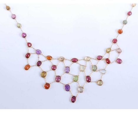 A yellow metal multi-stone fringe necklet, featuring oval faceted garnet, amethyst, peridot, topaz, citrine, lemon quartz and