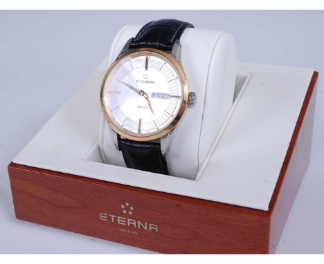 A gent's steel cased Eterna Artena quartz wristwatch, having signed silvered day/date dial with baton markers, gold plated be