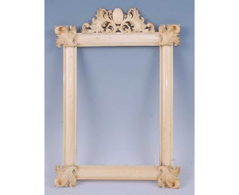 A Victorian ivory frame for portrait miniatures being ogee moulded with leaf carved applied corner mounts and frieze, 29x20cm