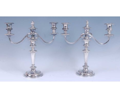 A pair of silver plated three-light candelabra in the Adam style by the Goldsmiths &amp; Silversmiths Company Ltd, the centra