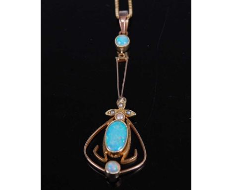 A yellow metal, opal and pearl fan shaped openwork pendant, comprising a centre opal cabochon suspended below a quatrefoil of