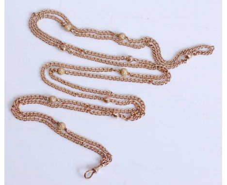 A 9ct yellow gold long guard chain, in the style of an open curblink, with six textured and five faceted circular beads and a