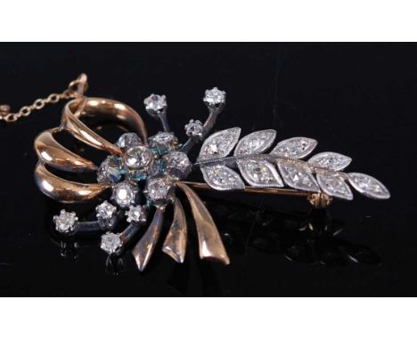 A yellow and white metal diamond spray brooch, comprising 23 Old European cut diamonds forming a flower and leaf design, with