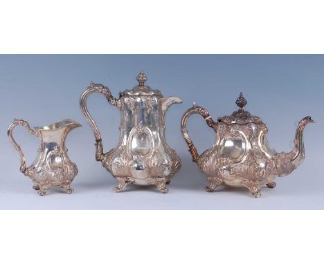 An Edwardian silver three piece tea and coffee service, comprising tea pot, coffee pot and cream jug, each of lobed pear shap