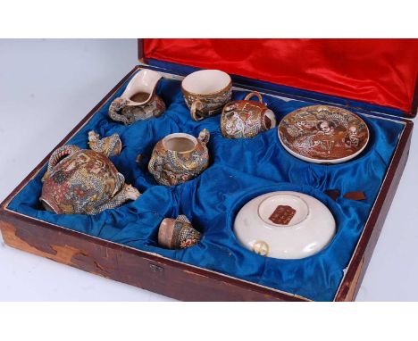 A Japanese Meiji period satsuma tea-for-two service, in fitted case, the whole decorated with figures and mythical serpents i