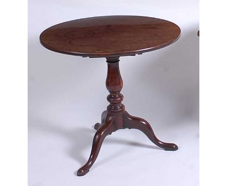 A George III mahogany pedestal tripod table, having a one-piece tilt-top to a baluster turned urn column, on hipped cabriole 