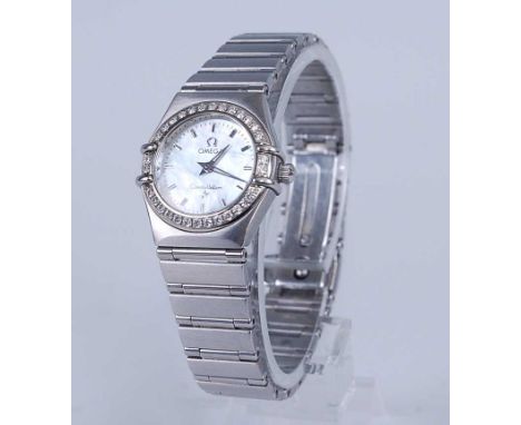 An Omega Constellation lady's steel cased quartz wristwatch, having a signed mother of pearl dial with baton markers, diamond