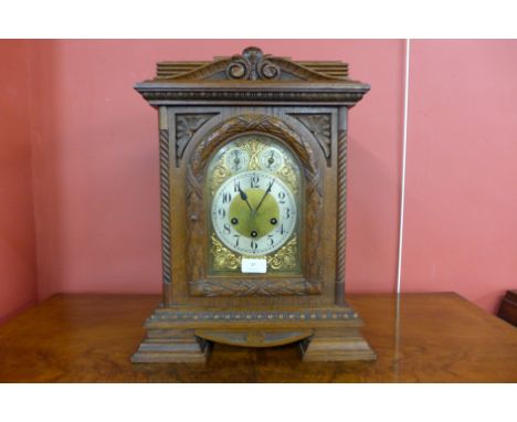 A 19th Century German Junghans carved oak bracket clock