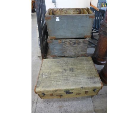 A steamer trunk and three military ammunition boxes