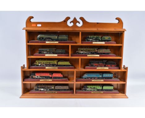 A WOODEN WALL MOUNTED OR TABLE TOP SHELVING UNIT, housing a collection of of ten Atlas Editions 'Locomotive Legends' series s