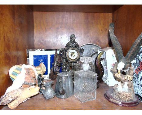 A Shelf of Decorative Items, to include a figural mantel clock, jelly mould, decanter and stopper, etc.