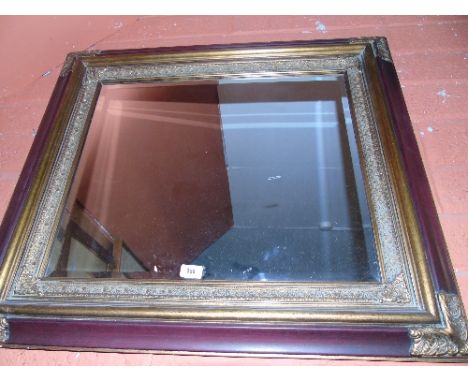 A Bevelled Wall Mirror with Decorative Frame.