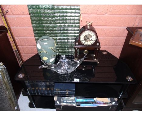 A Black Glass and Chrome T.V. Stand together with an art glass, a pottery vase, tin clock, Empire style mantel clock, and boo