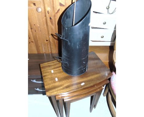 A 20th Century Mahogany Nest of Tables along with a coal helmet and poker.