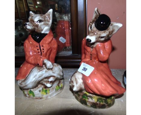 A Pair of Staffordshire Pottery Foxes in Hunting Dress, 20cm high (2). 