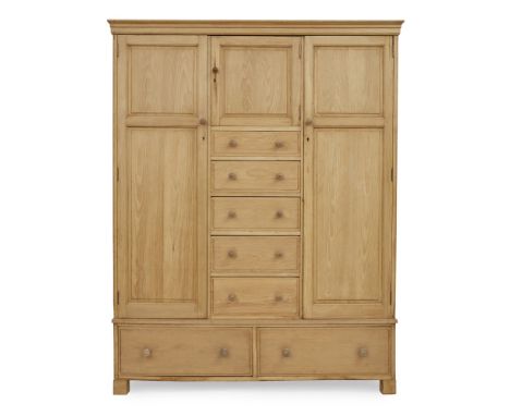 HEAL &amp; SONS  OAK COMPACTUM, CIRCA 1925   with central panelled door above five graduated drawers, flanked by two further 