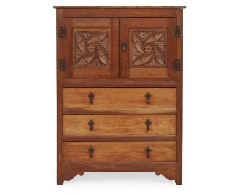 LIBERTY &amp; CO., LONDON  ARTS &amp; CRAFTS OAK CABINET, CIRCA 1920   the projecting cornice above two doors with relief-car