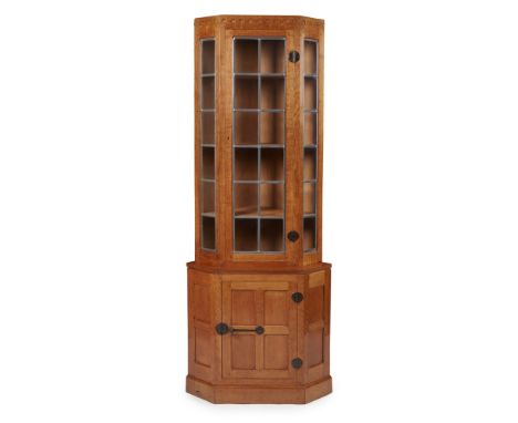 ROBERT 'MOUSEMAN' THOMPSON (1876-1955)  OAK CORNER CABINET, 1970s with single door having inset leaded glass panels, flanked 