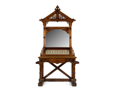 ENGLISH SCHOOL  GOTHIC REVIVAL OAK HALLSTAND, CIRCA 1890   the chamfered frame with pierced cresting and central mirror surro