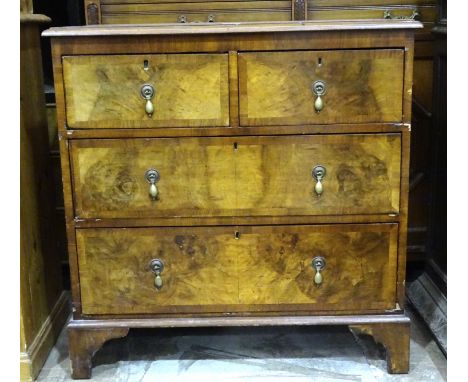 A walnut chest of two short and two long cross-banded drawers, on bracket feet, 81cm wide, 85cm high, an Edwardian mahogany o