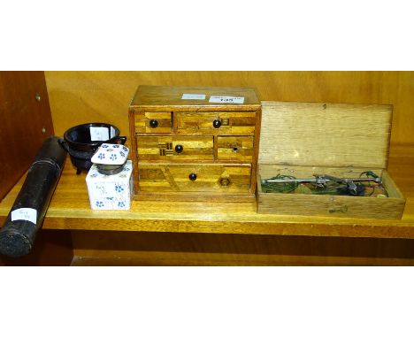 A set of brass and steel travelling scales and weights in case, a miniature wooden jewellery chest of five drawers, 14.5cm wi
