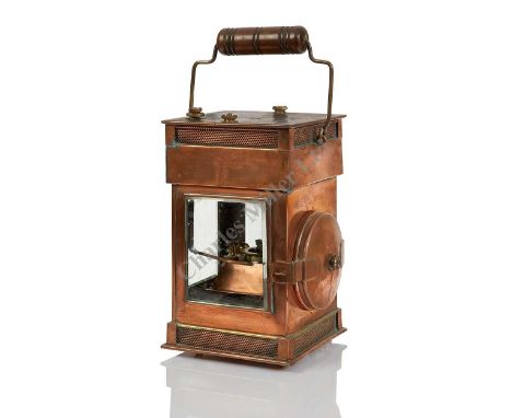 A RARE HAND-CARRIED COPPER AND BRASS MAGAZINE OIL LAMP, CIRCA 1900, the bevelled glass windows with external brightness and e