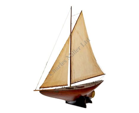 A FINE PLANKED AND PINNED MAHOGANY GAFF-RIGGED POND YACHT NAMED BETTY, CIRCA 1920, the hull pinned with trenails, lead keel, 