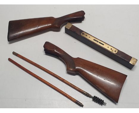 Two wooden gun stocks with cleaning brush and a vintage wooden spirit level