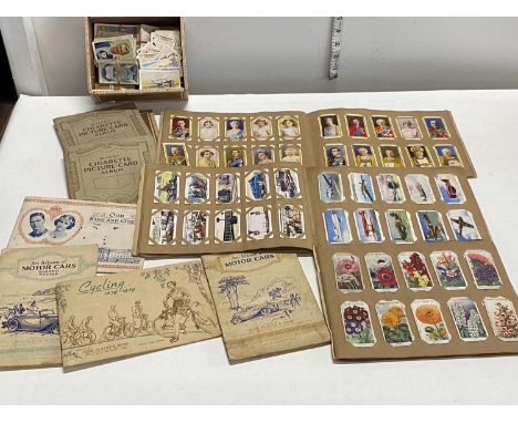 A selection of vintage cigarette card albums and loose cards including full sets