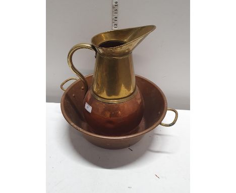 A antique brass and copper jug with a copper basin, shipping unavailable