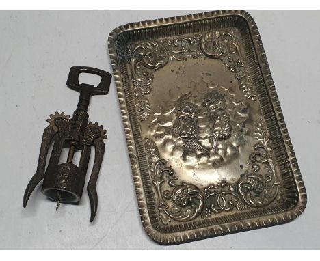 A vintage gilded tray with a vintage corkscrew